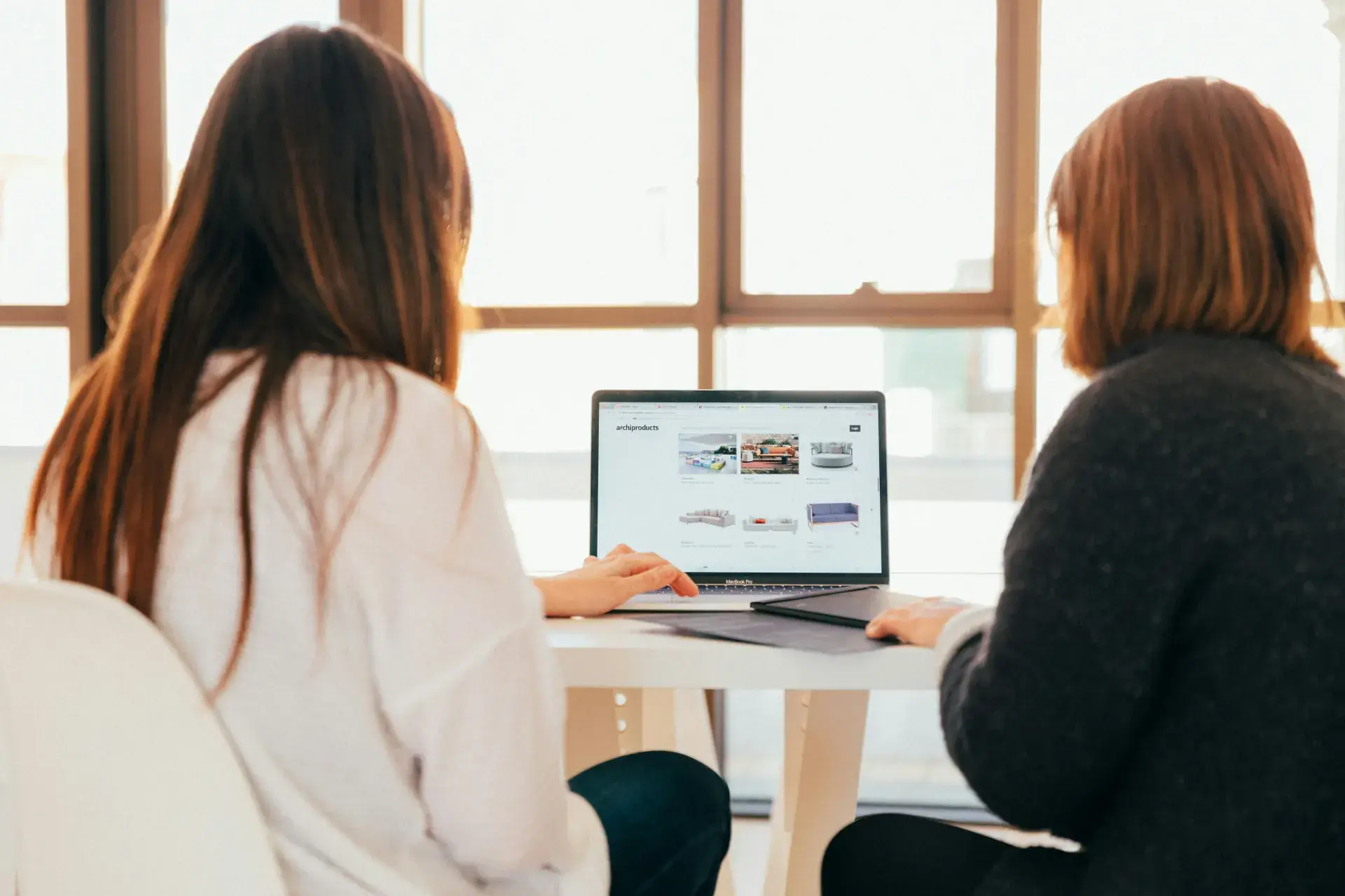 Two colleagues collaborating at a laptop